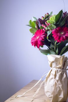 Bouquet of flowers with highlighted red daisy