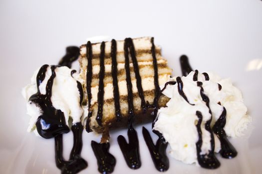 Dessert with chocolate syrup on cream