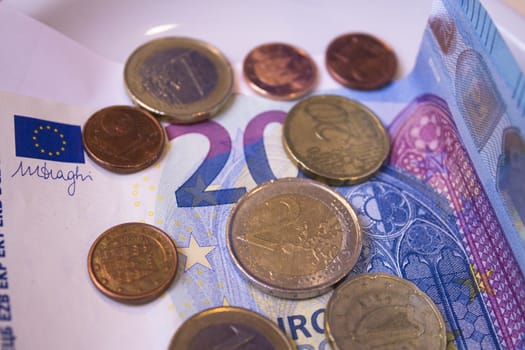Banknotes and euros on plate
