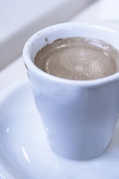 Hot coffee drink in a white cup