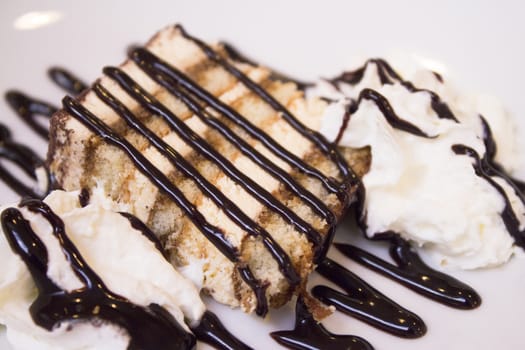 Dessert with chocolate syrup on cream