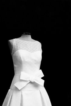 Mannequin with white basic wedding dress