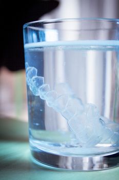 Invisible dental orthodontic submerged in water for cleaning