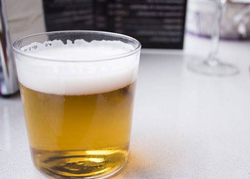 Beer glass in glass on top of a wooden table