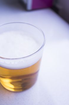 Beer glass in glass on top of a wooden table