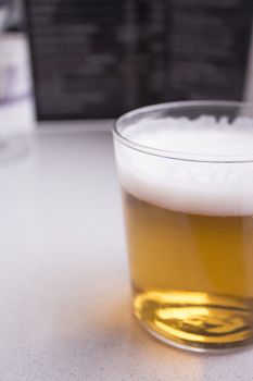 Beer glass in glass on top of a wooden table