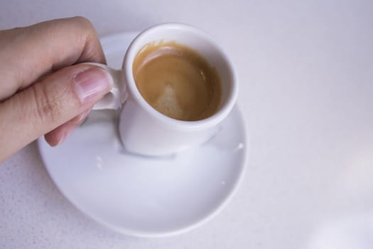 Cafeteria table with white cup of coffee