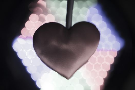 Heart on multicolored background out of focus