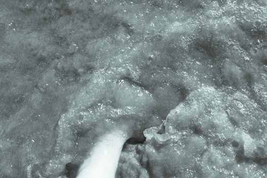 Beach scene with woman feet on the sand. Nails of feet painted red