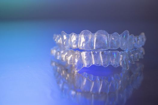 Plastic dental orthodontics on colored background. No people
