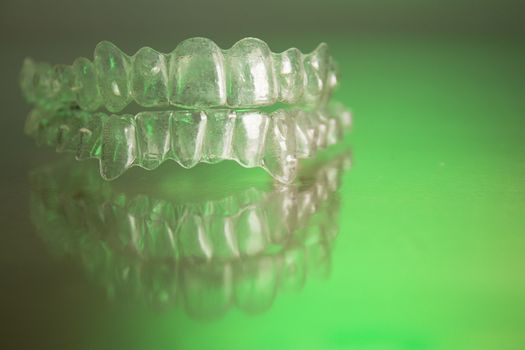 Plastic dental orthodontics on colored background. No people
