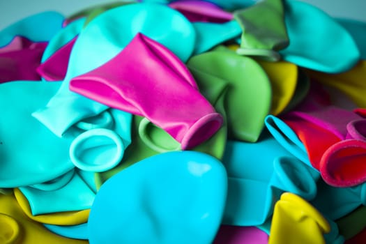 Group of deflated balloons of various colors
