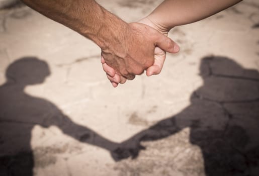 Hands of two lovers intertwined
