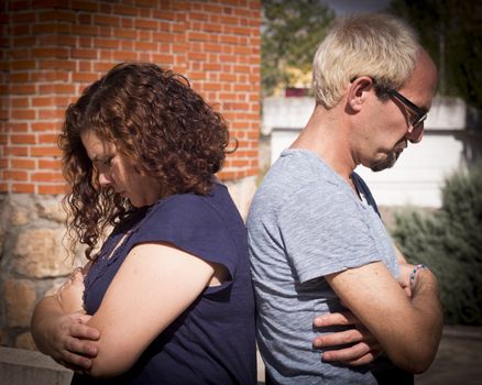 Man and woman back to back angry