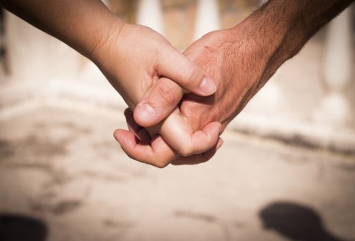 Hands of two lovers intertwined