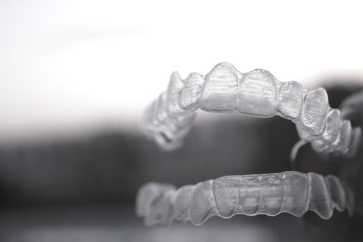 Invisible orthodontics for aligning teeth