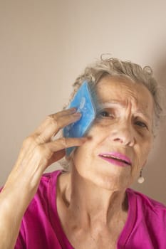 Ice pack for headache in older woman
