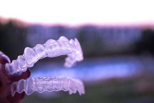 Invisible orthodontics for aligning teeth