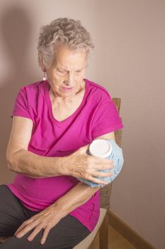 Ice pack on older woman arm to relieve pain