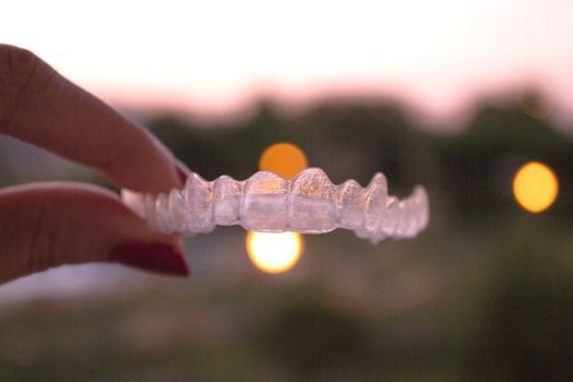 Invisible orthodontics for aligning teeth