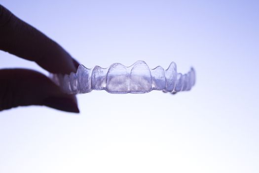 Invisible orthodontics for aligning teeth