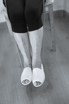 Rehabilitation exercises with elastic resistance rubber for older woman with cerebral stroke