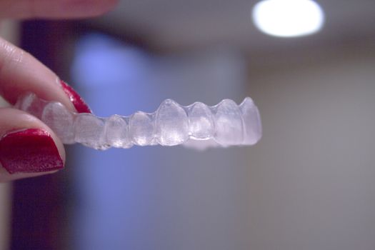 Invisible orthodontics for aligning teeth