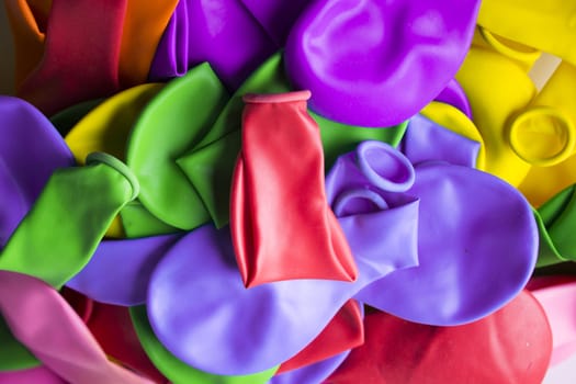 Group of deflated balloons of various colors