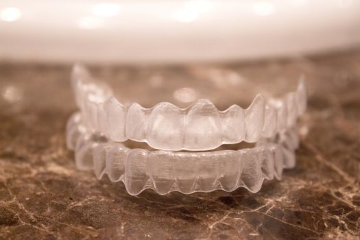 Invisible orthodontics for aligning teeth