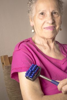 Elderly self massaging the body for pain