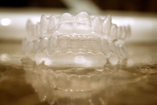 Invisible orthodontics for aligning teeth