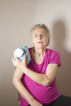 Ice pack on older woman arm to relieve pain
