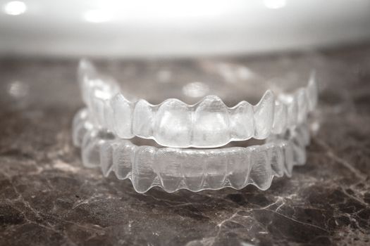 Invisible orthodontics for aligning teeth