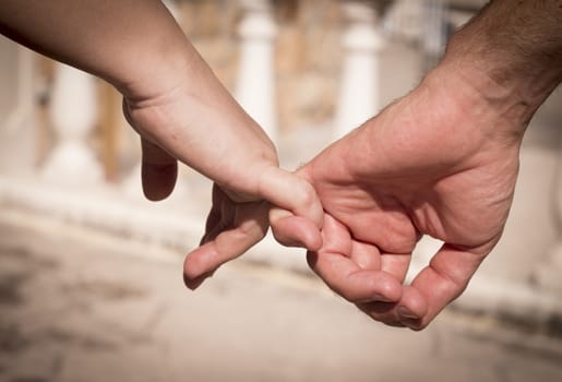 Hands of two lovers intertwined
