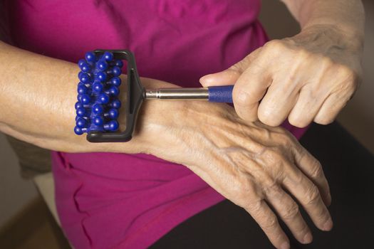 Elderly self massaging the body for pain