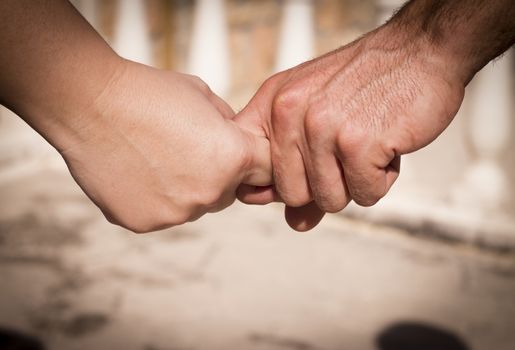 Hands of two lovers intertwined