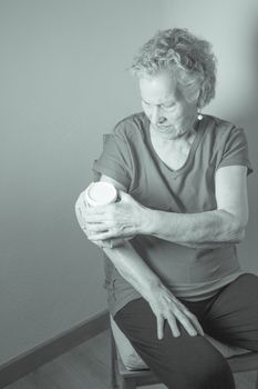 Ice pack on older woman arm to relieve pain