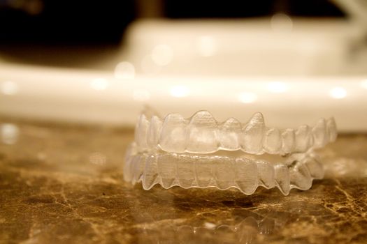 Invisible orthodontics for aligning teeth