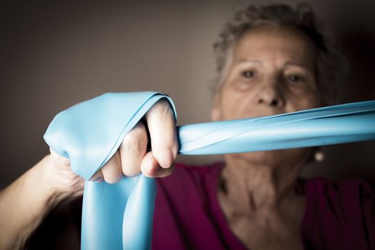 Rehabilitation exercises for older women with elastic band