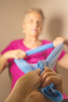 Rehabilitation exercises for older women with elastic band