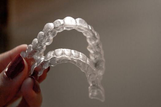 Invisible orthodontics for aligning teeth