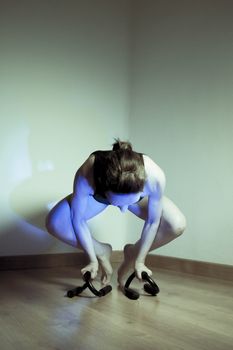 Woman initiating crow movement in yoga