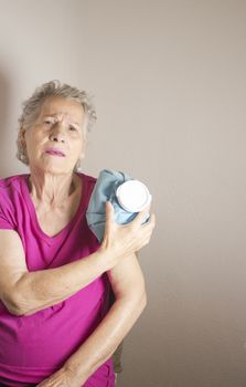 Ice pack on older woman arm to relieve pain