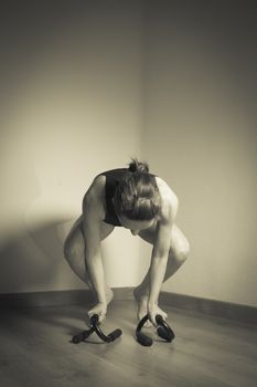 Woman initiating crow movement in yoga