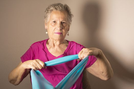 Rehabilitation exercises for older women with elastic band