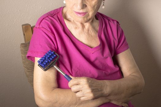 Elderly self massaging the body for pain