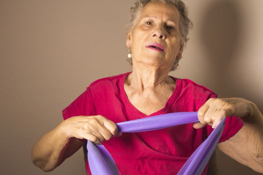 Rehabilitation exercises for older women with elastic band