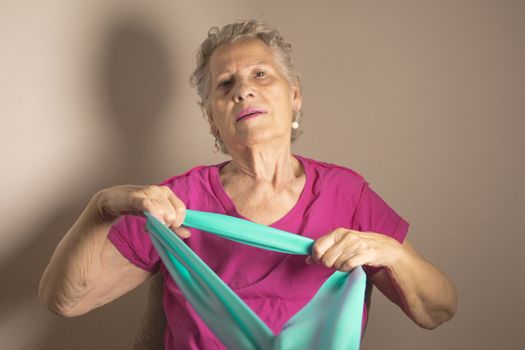 Rehabilitation exercises for older women with elastic band