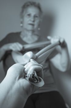 Rehabilitation exercises for older women with elastic band