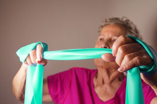 Rehabilitation exercises for older women with elastic band